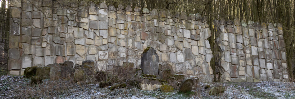 A sturdy stone wall made of irregularly shaped stones, showcasing a natural and weathered appearance.